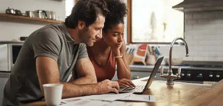 couple on a laptop in the kitchen