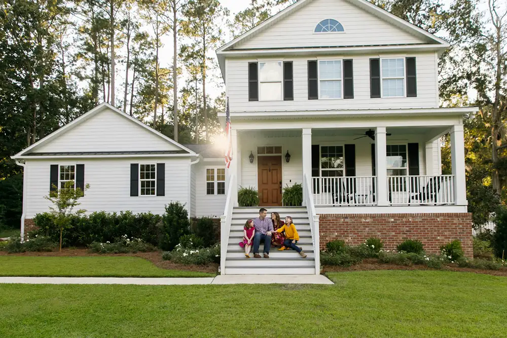 family in front of house