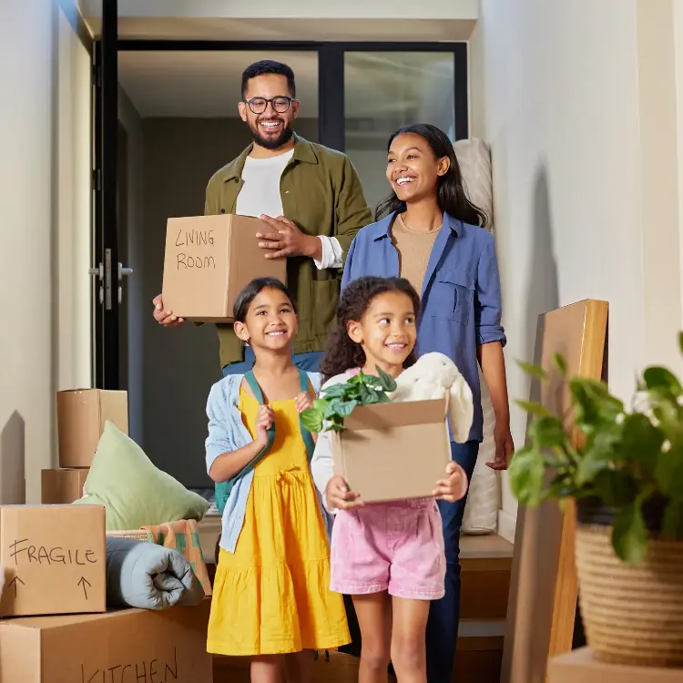 family in new home with moving boxes