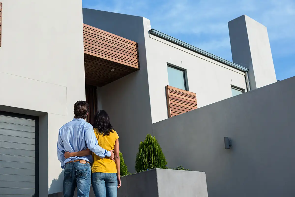 couple in front of modern house
