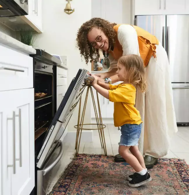 girl opening an oven