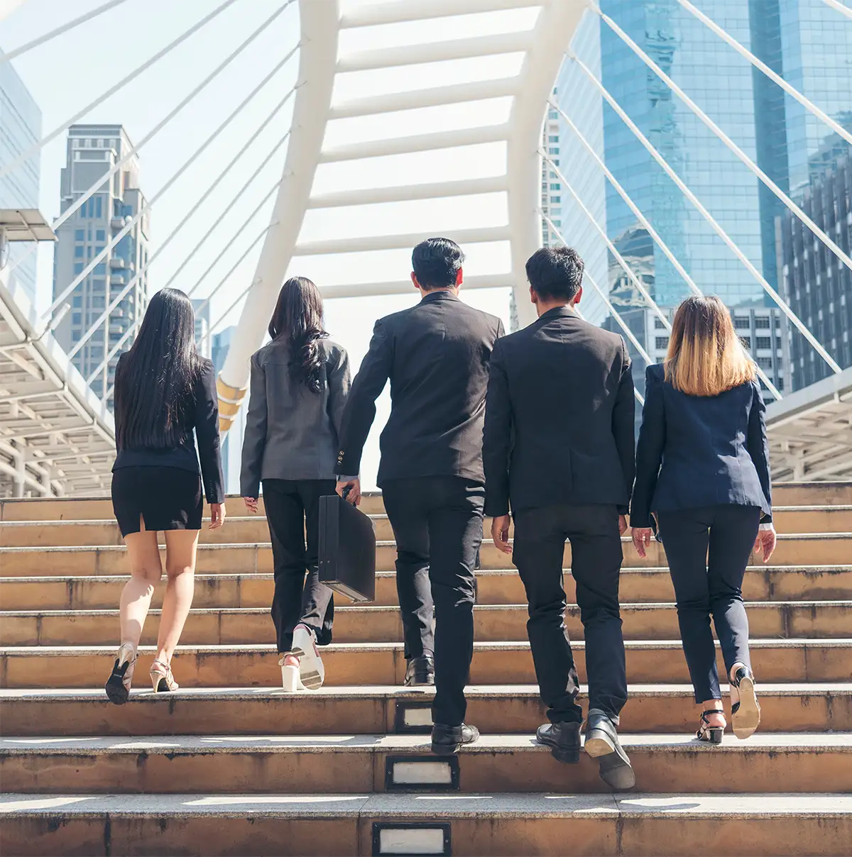 group of people walking up stairs from the back
