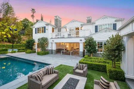 A large white house with inground pool