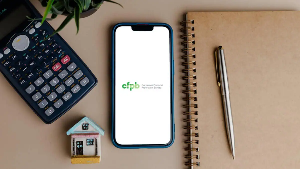Phone, calculator, notebook, and other items on a desk