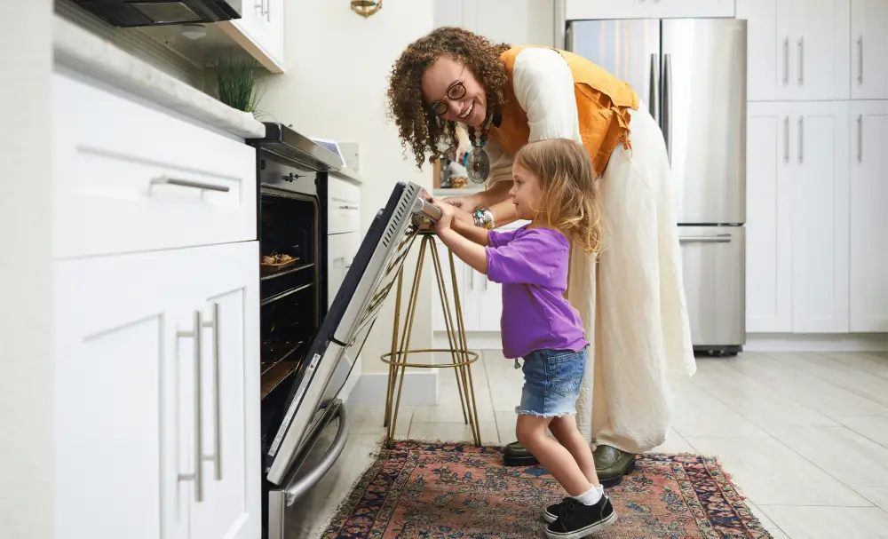 mother and child opening oven