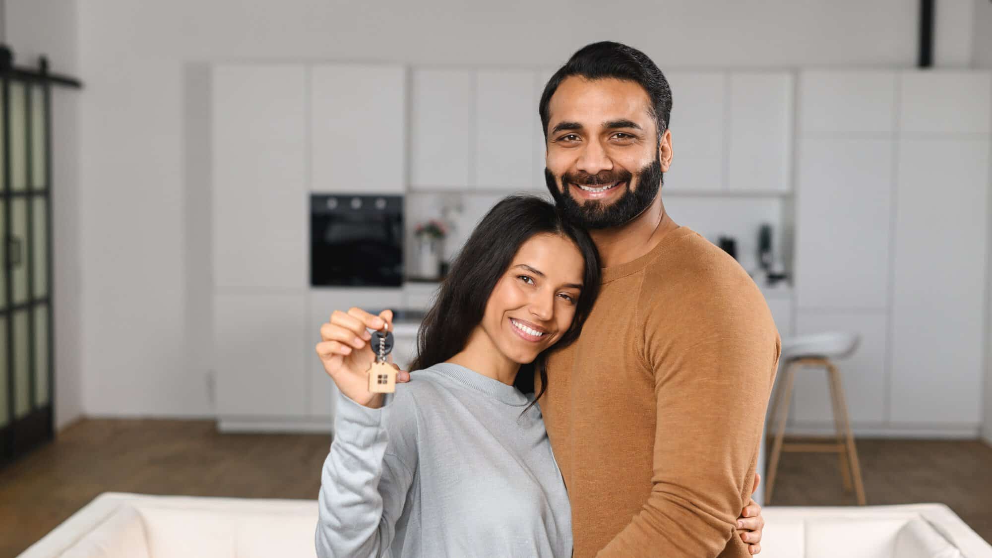 A couple holding a key
