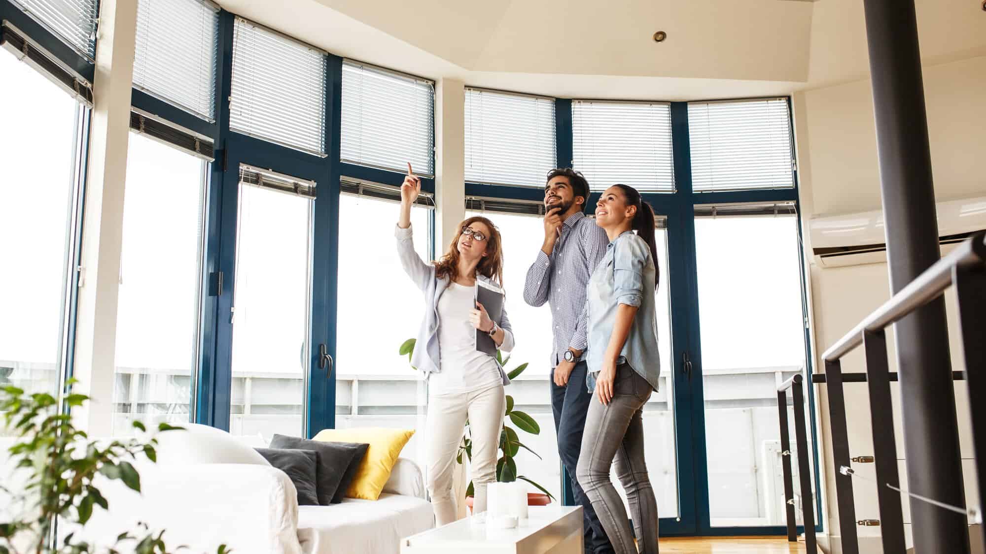 A realtor and couple in a house