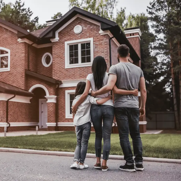 Family looking at front of a house