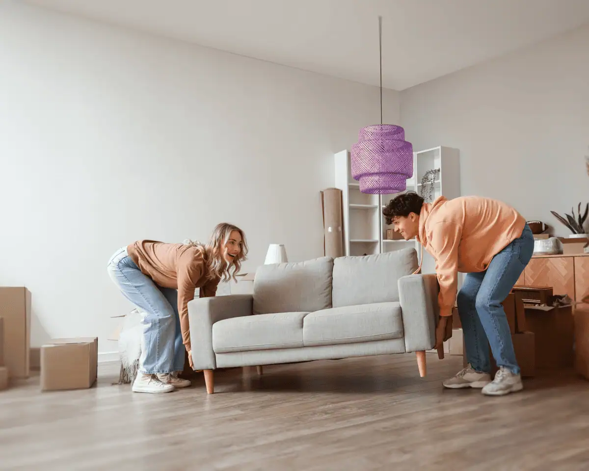 Young couple moving a couch