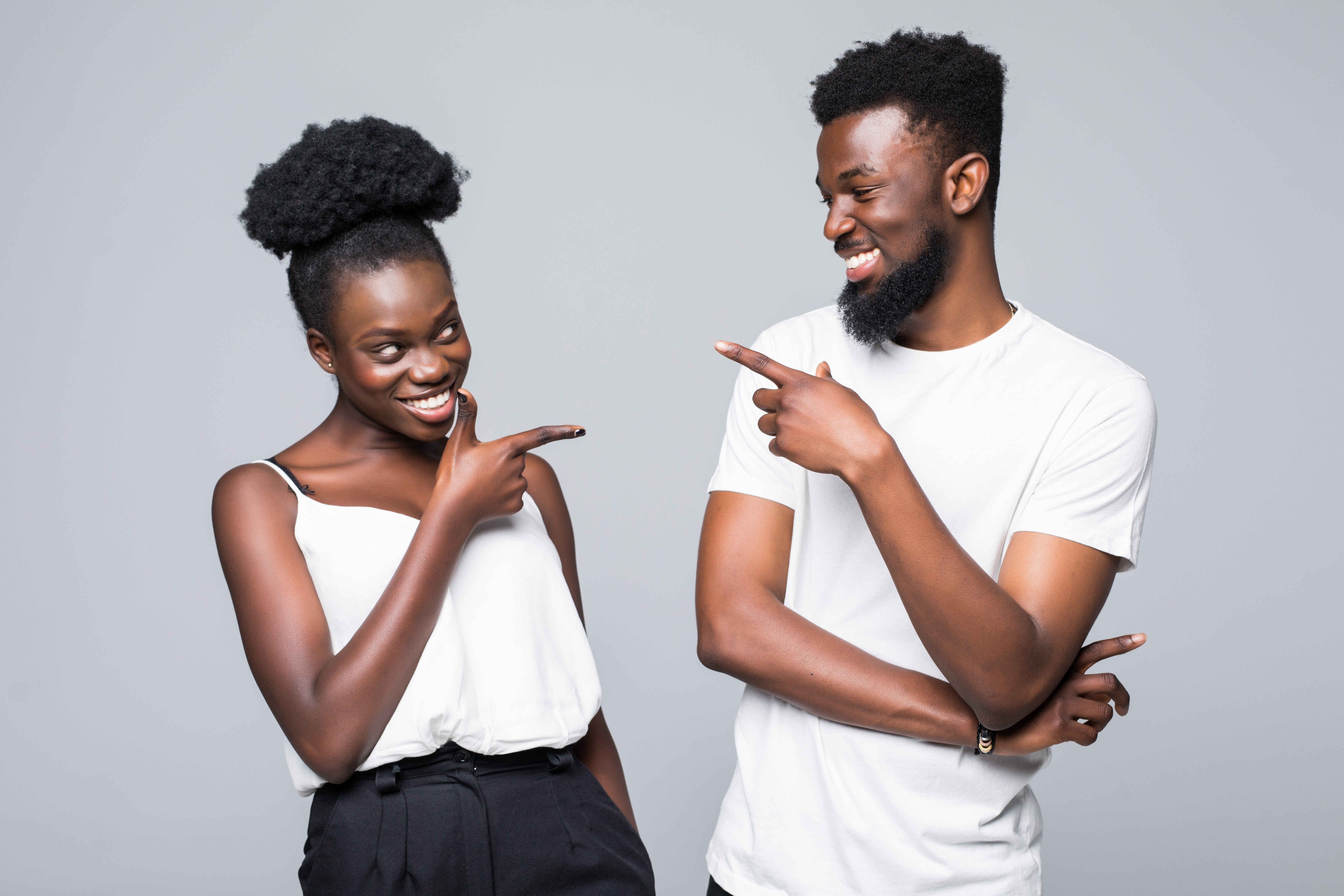 People pointing at each other and smiling