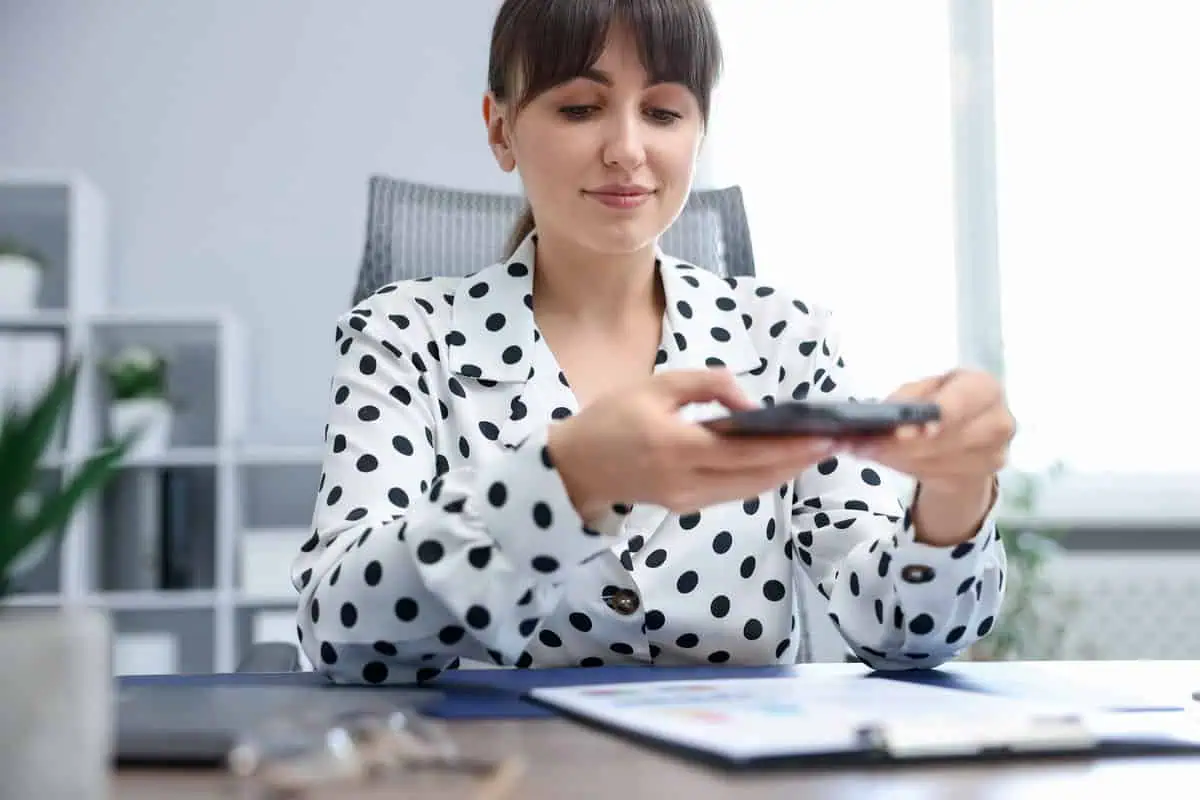 Person scanning document with phone