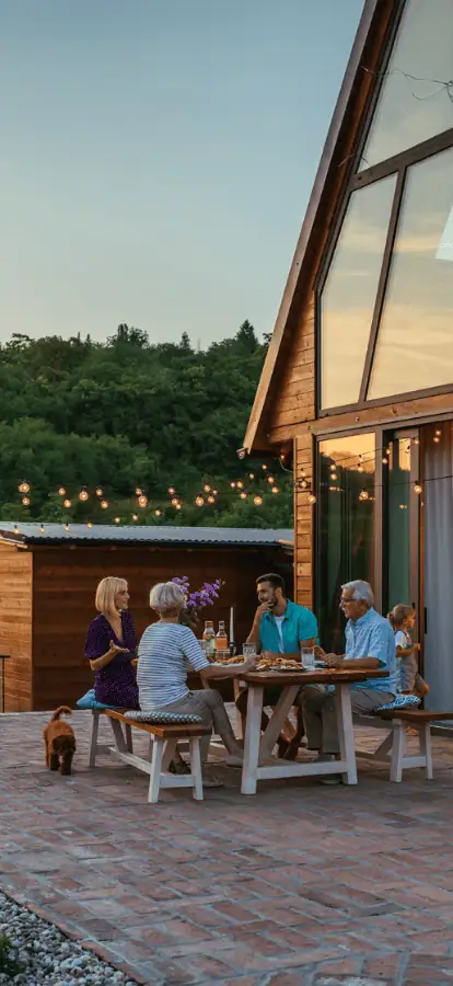 Family eating at table on back patio