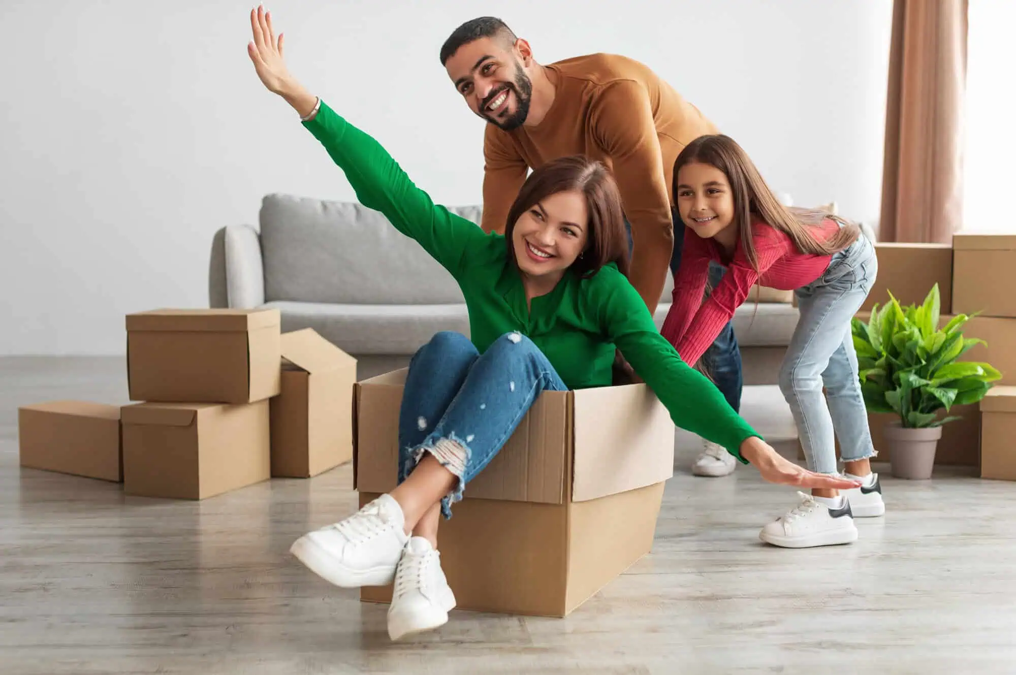 Girl sitting in a cardboard box