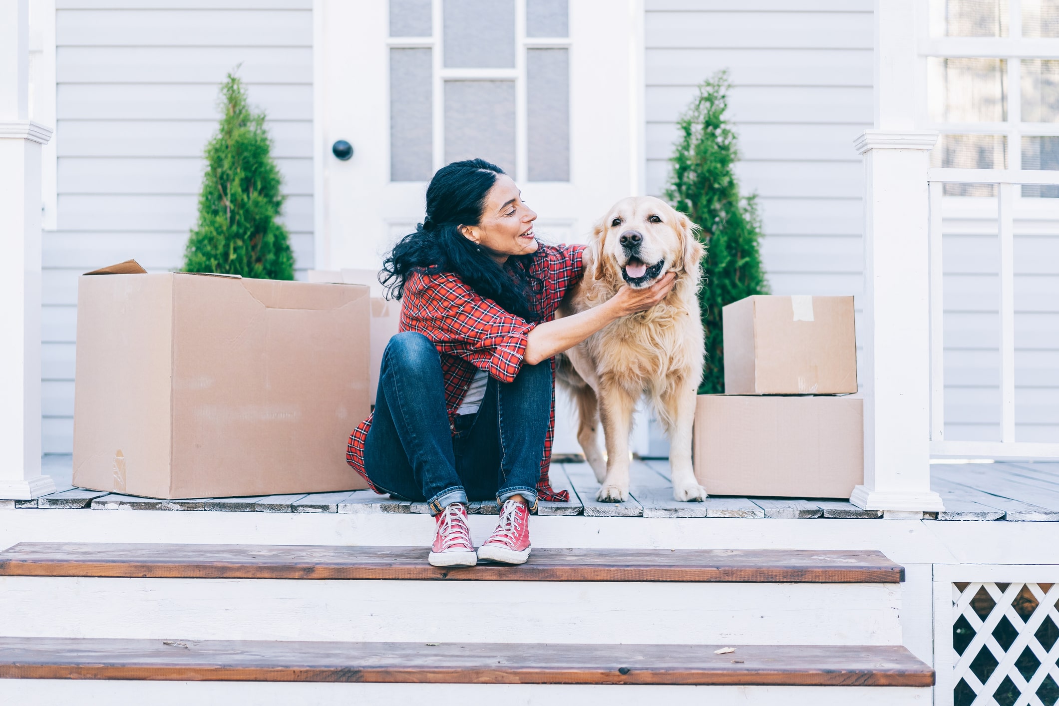 women on steps petting a dog