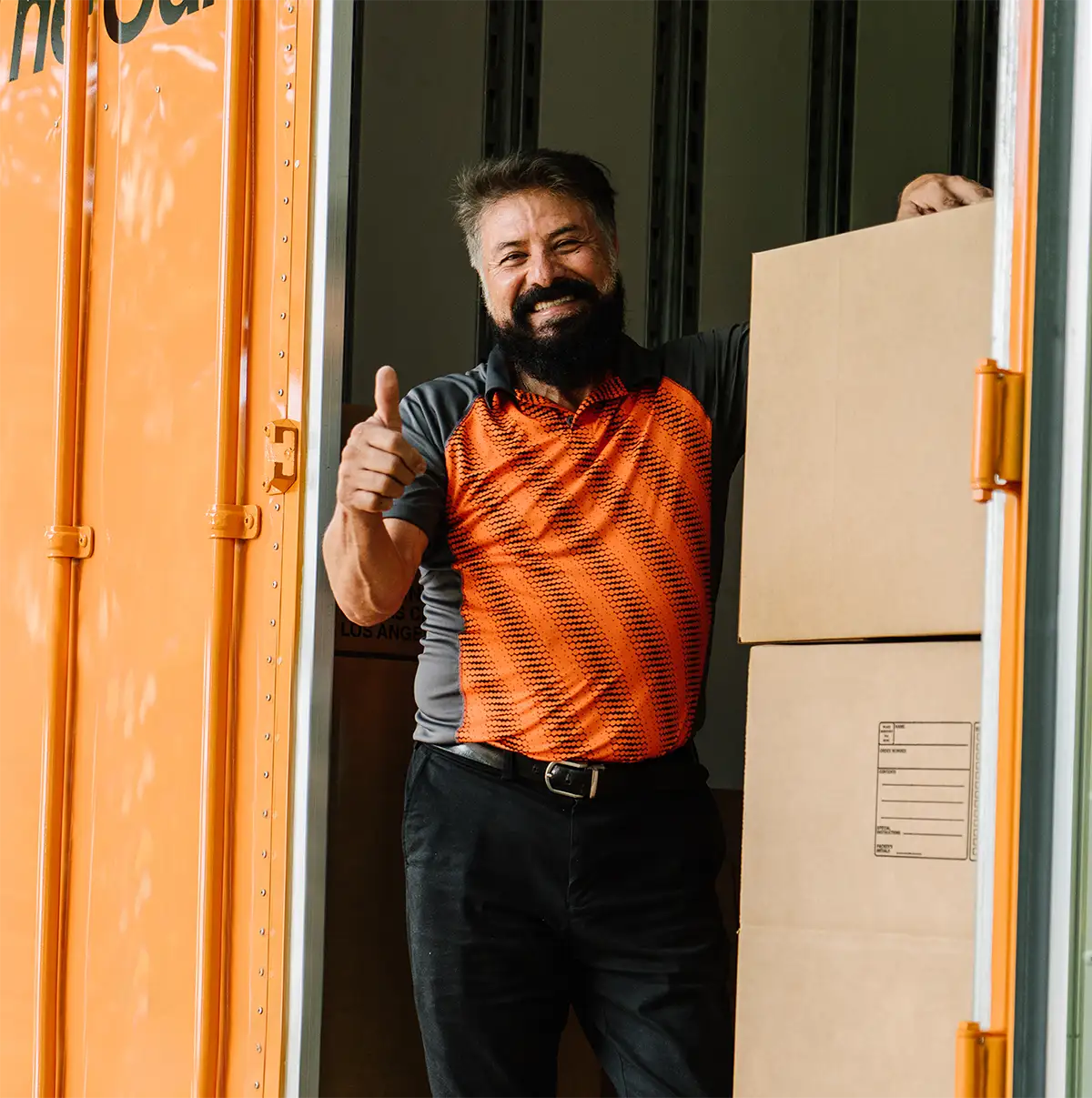 guy giving thumbs up next to moving boxes