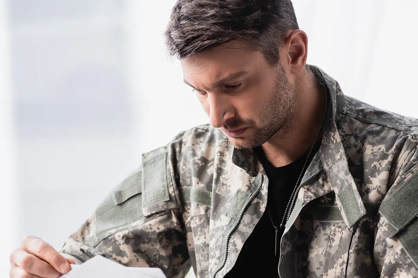 service member opening a letter