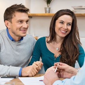 couple speaking with closing agent during closing process