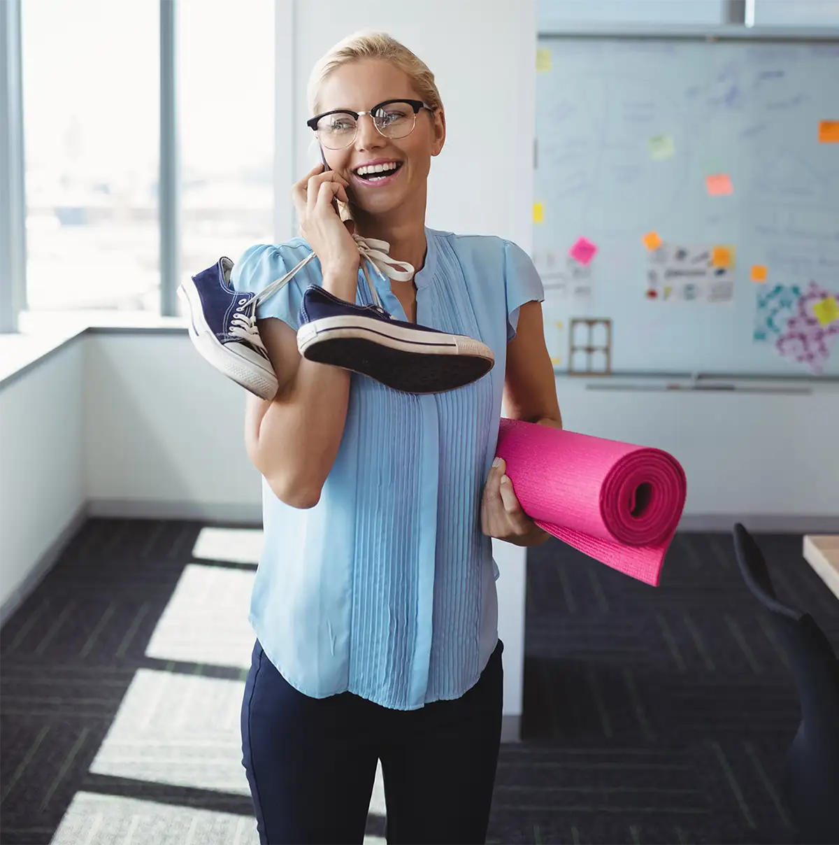 woman on phone with shoes and yoga mat