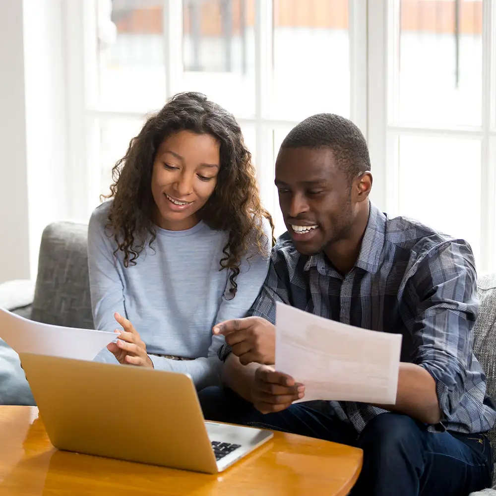 couple at laptop looking at document