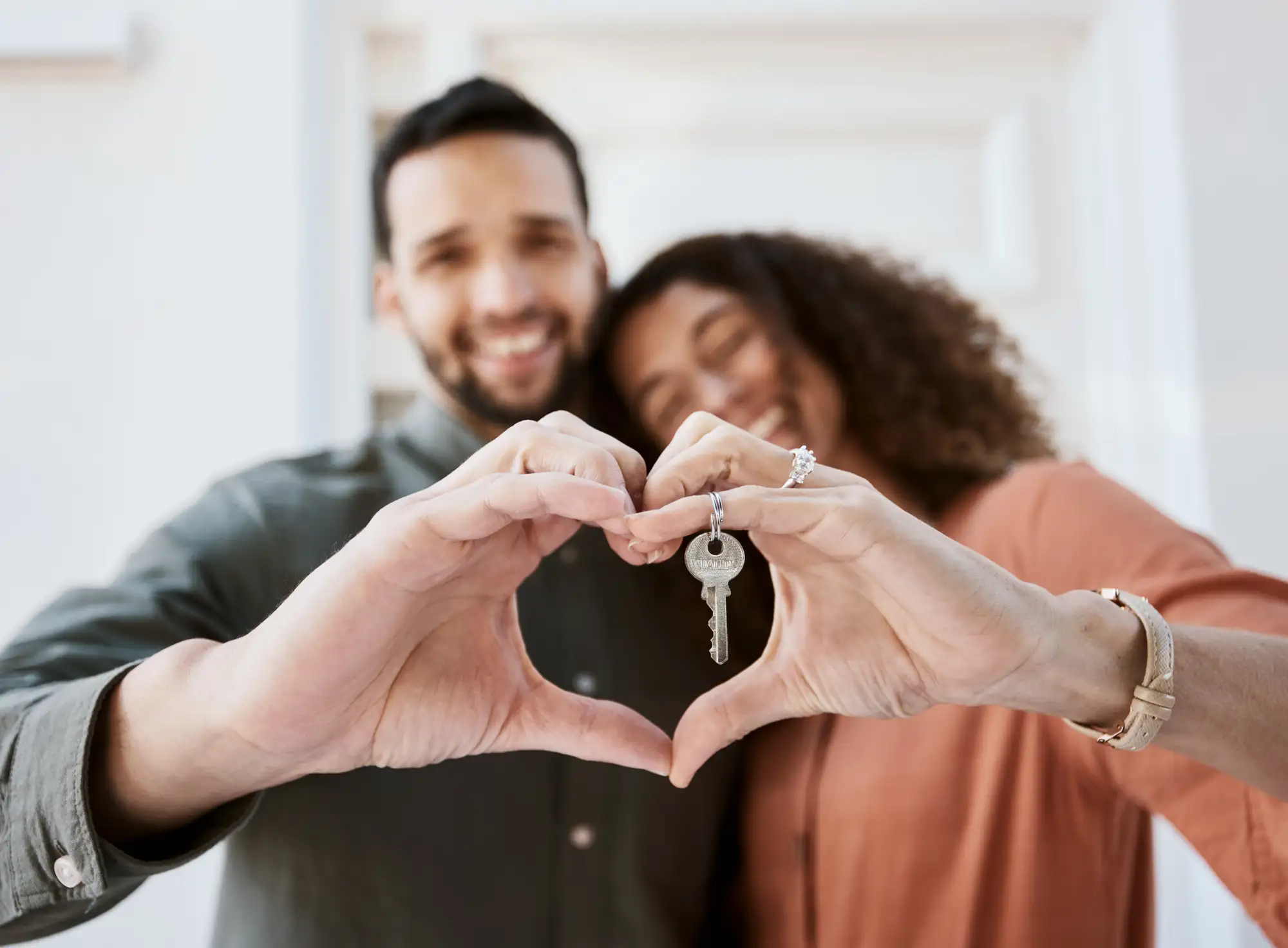 couple making a heart with their hands