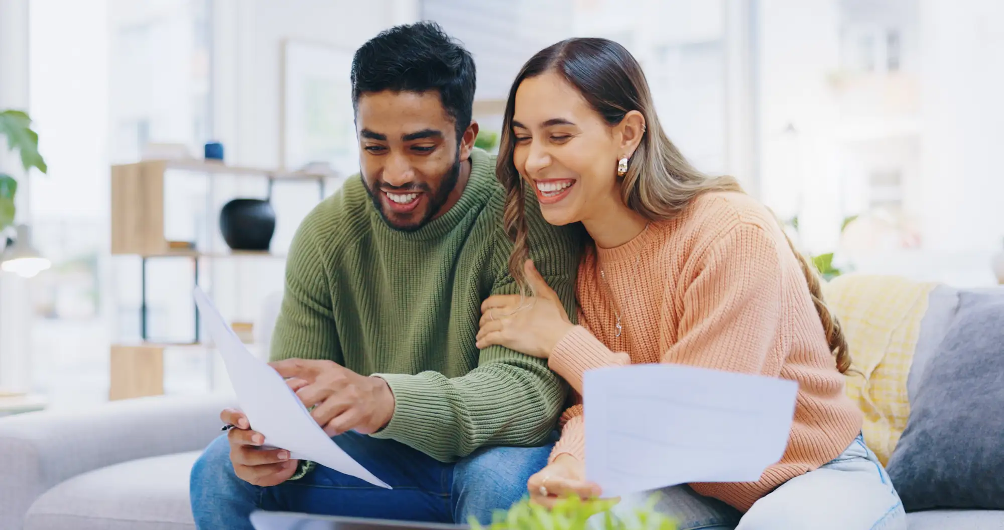 couple smiling looking at papers