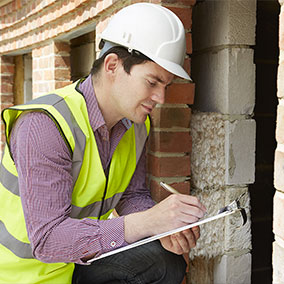 inspector writing on clipboard