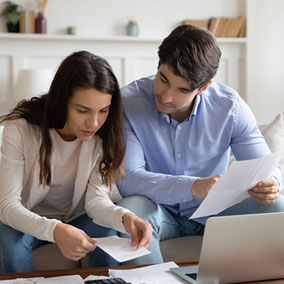 couple reviewing documents at table