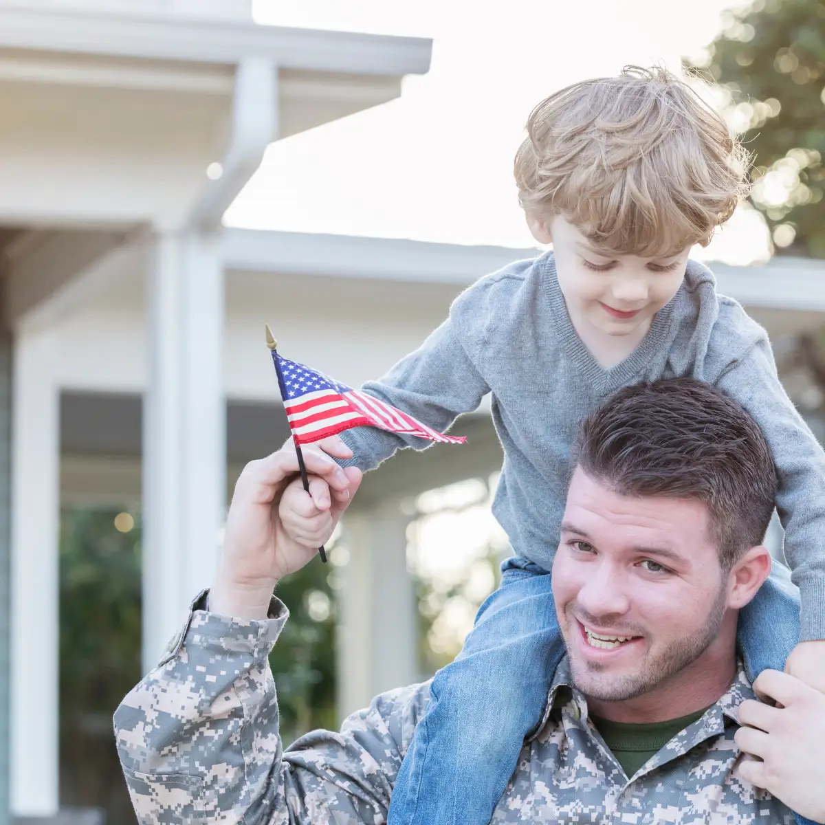 serviceman father with child on shoulders