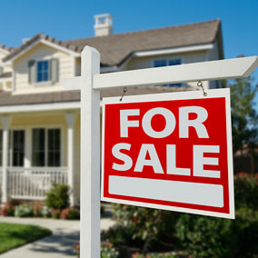 for sale sign in front of home