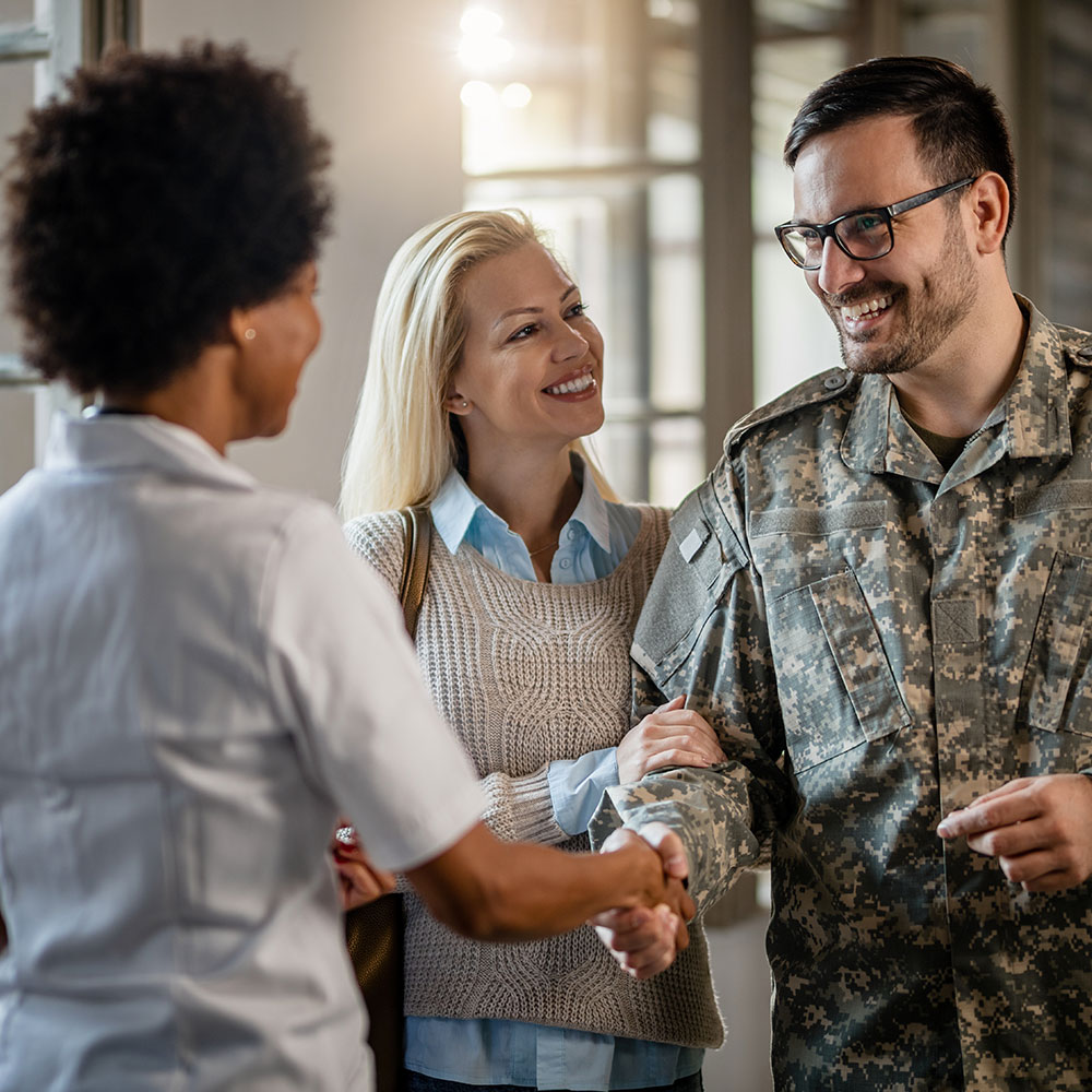 mortgage lender shaking veteran's hand after he secures a VA loan 