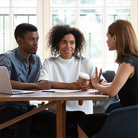 Couple discussing homeowners insurance with a mortgage lender