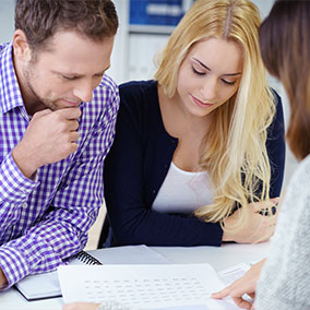 man and woman reviewing mortgage insurance documents