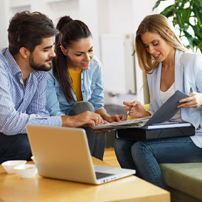 Couple reviewing mortgage process with loan officer