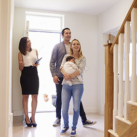 couple viewing house with real estate agent