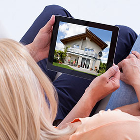 Woman looking at house out of state