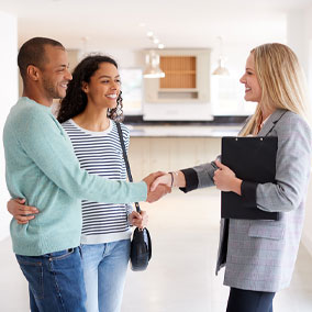 couple speaking to real estate agent