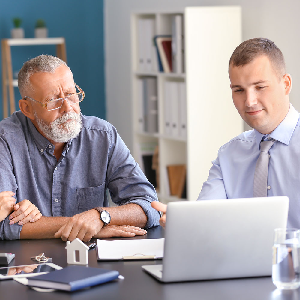 older man speaking with an experienced loan officer 